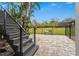 Modern dark-stained wooden stairs leading to backyard at 5906 N Kenneth Ave, Tampa, FL 33604