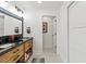 Bathroom with double vanity and access to another room at 5906 N Kenneth Ave, Tampa, FL 33604