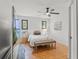 Bright bedroom with tiled floors, a queen bed and a large TV at 5906 N Kenneth Ave, Tampa, FL 33604