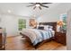 Spacious bedroom with hardwood floors and a large bed at 5906 N Kenneth Ave, Tampa, FL 33604
