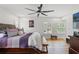 Main bedroom with hardwood floors and large windows at 5906 N Kenneth Ave, Tampa, FL 33604