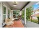 Covered deck with rocking chairs and comfortable seating at 5906 N Kenneth Ave, Tampa, FL 33604