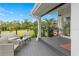 Deck with wicker furniture and tranquil backyard views at 5906 N Kenneth Ave, Tampa, FL 33604