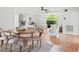 Casual dining area with wood table and chairs, adjacent to living room at 5906 N Kenneth Ave, Tampa, FL 33604