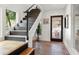 Bright entryway with brick flooring, modern staircase, and etched glass door at 5906 N Kenneth Ave, Tampa, FL 33604