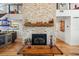 Impressive stone fireplace with a rustic wood mantel at 5906 N Kenneth Ave, Tampa, FL 33604