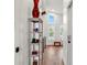 Bright hallway with hardwood floors and a stylish shelf at 5906 N Kenneth Ave, Tampa, FL 33604