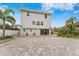 Two-story house back with paver driveway and landscaping at 5906 N Kenneth Ave, Tampa, FL 33604