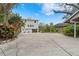 Two-story house back with large driveway and landscaping at 5906 N Kenneth Ave, Tampa, FL 33604