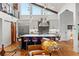 Spacious kitchen boasts an island with seating, stainless steel appliances, and hardwood floors at 5906 N Kenneth Ave, Tampa, FL 33604