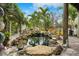 Serene backyard koi pond with waterfall feature and lush landscaping at 5906 N Kenneth Ave, Tampa, FL 33604