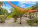 Landscaped backyard with shade sail and ferns at 5906 N Kenneth Ave, Tampa, FL 33604