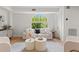 Relaxing living room featuring a comfortable sofa and large window at 5906 N Kenneth Ave, Tampa, FL 33604