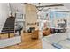Open living area with high ceilings, hardwood floors, and a stunning stone fireplace at 5906 N Kenneth Ave, Tampa, FL 33604