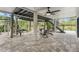 Covered patio area with brick flooring and seating at 5906 N Kenneth Ave, Tampa, FL 33604