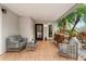 Relaxing patio features wicker furniture, wood stack, and access to the home at 5906 N Kenneth Ave, Tampa, FL 33604