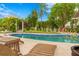 Stunning pool and lounge area with a tranquil backyard view at 5906 N Kenneth Ave, Tampa, FL 33604