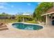 Inviting kidney-shaped pool with a spacious patio and lounge chairs at 5906 N Kenneth Ave, Tampa, FL 33604