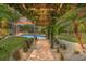 Relaxing pool area with brick pathway and pergola at 5906 N Kenneth Ave, Tampa, FL 33604
