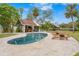 Relaxing kidney-shaped pool with patio and pool bar at 5906 N Kenneth Ave, Tampa, FL 33604