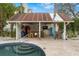 Outdoor pool bar with rustic details and seating at 5906 N Kenneth Ave, Tampa, FL 33604