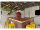 L-shaped pool bar with rustic wood and yellow stools at 5906 N Kenneth Ave, Tampa, FL 33604