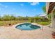 Relaxing kidney-shaped pool with patio and lounge chairs at 5906 N Kenneth Ave, Tampa, FL 33604