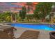 Inviting kidney-shaped pool with lounge chairs and lush landscaping at 5906 N Kenneth Ave, Tampa, FL 33604