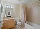 Well-lit bathroom with tub, shower, and granite vanity at 628 Cleveland St # 1201, Clearwater, FL 33755
