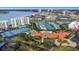 Aerial view showing community amenities including tennis courts and a pool at 7893 Sailboat Key S Blvd # 304, South Pasadena, FL 33707