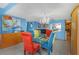 Dining room with chandelier and view into kitchen at 7893 Sailboat Key S Blvd # 304, South Pasadena, FL 33707
