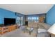 Living room with large sectional sofa and water views at 7893 Sailboat Key S Blvd # 304, South Pasadena, FL 33707
