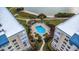 Community pool with lounge chairs; aerial view at 7893 Sailboat Key S Blvd # 304, South Pasadena, FL 33707