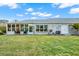 Large backyard with grassy lawn and screened porch at 8086 Annwood Rd, Seminole, FL 33777