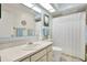 Clean bathroom with light blue walls, a vanity, and shower/tub combo at 8086 Annwood Rd, Seminole, FL 33777