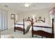 Bright bedroom featuring two twin beds with wooden frames at 8086 Annwood Rd, Seminole, FL 33777