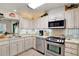 Well-equipped kitchen with stainless steel appliances and white cabinetry at 8086 Annwood Rd, Seminole, FL 33777
