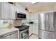 Stainless steel appliances and ample white cabinetry in this well-lit kitchen at 8086 Annwood Rd, Seminole, FL 33777