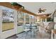 Bright sunroom with a glass-topped table and wicker chairs at 8086 Annwood Rd, Seminole, FL 33777