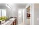 Bathroom with granite countertop, walk-in shower, and closet at 10251 Carloway Hills Dr, Wimauma, FL 33598