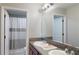 Bathroom with granite countertop, double sinks, and shower at 10251 Carloway Hills Dr, Wimauma, FL 33598
