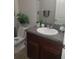 Modern bathroom with a granite countertop vanity and updated fixtures at 10251 Carloway Hills Dr, Wimauma, FL 33598