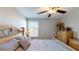 Spacious bedroom with a large bed, dresser, and window at 10251 Carloway Hills Dr, Wimauma, FL 33598
