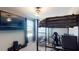 Bedroom with loft bed, gaming chair, and large TV at 10251 Carloway Hills Dr, Wimauma, FL 33598