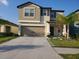 Two-story house with a two-car garage and well-manicured lawn at 10251 Carloway Hills Dr, Wimauma, FL 33598