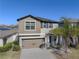 Two-story house with tan siding, gray shutters, and a two-car garage at 10251 Carloway Hills Dr, Wimauma, FL 33598