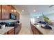 Modern kitchen with stainless steel appliances and granite counters at 10251 Carloway Hills Dr, Wimauma, FL 33598