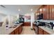 Modern kitchen with granite countertops and dark wood cabinets at 10251 Carloway Hills Dr, Wimauma, FL 33598