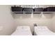 Clean laundry room, washer, dryer, and storage shelves at 10251 Carloway Hills Dr, Wimauma, FL 33598