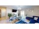 Living room featuring a blue sectional sofa and a modern fireplace at 10251 Carloway Hills Dr, Wimauma, FL 33598